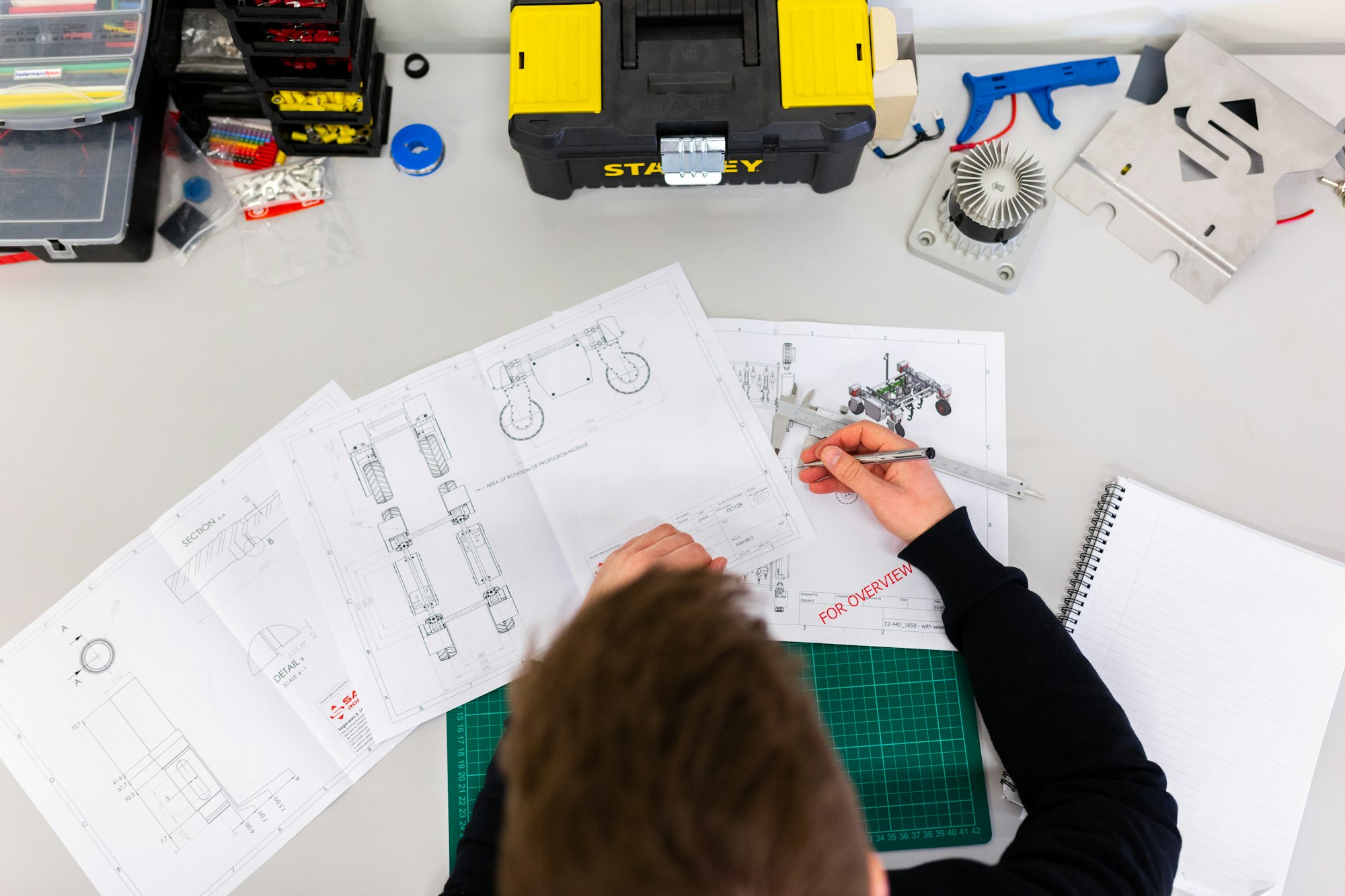 Engineer servicing commercial refrigeration equipment in a professional workshop setting